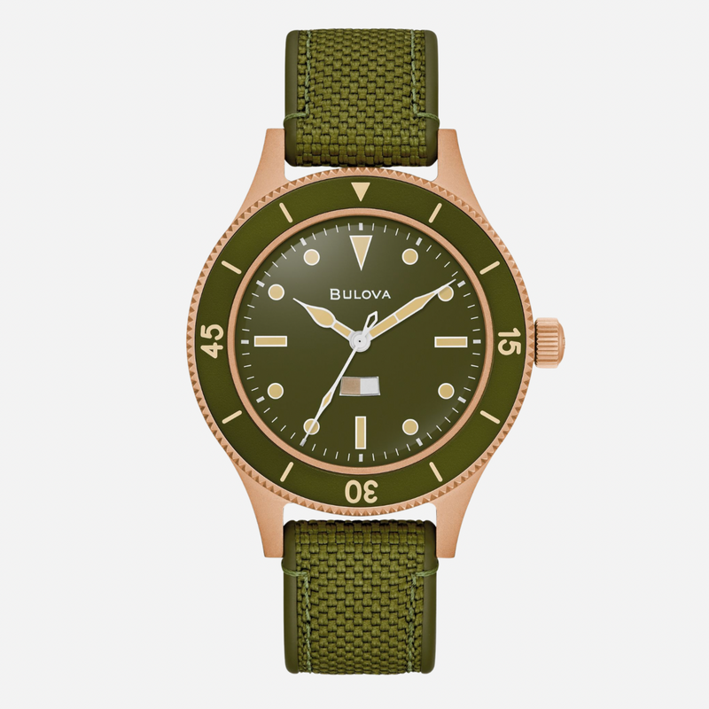 Green watch with rose gold accents on a white background