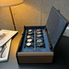 Side view of the open AUBLIQ 10-slot watch box, showing brown side panels, blue lining and two rows of five watches.