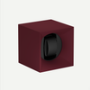 Maroon watch winder with a black watch inside on a white background