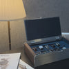 Open AUBLIQ silver 10-slot watch box with ten watches, blue lining, brown side panels, a covered strap compartment and soft close lid.