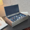 AUBLIQ silver 12-slot watch box displaying twelve watches on blue cushions, with brown side panels, a padded lid and soft close lid.